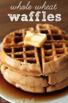 a stack of waffles sitting on top of a white plate covered in syrup