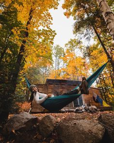 a woman laying in a hammock with her feet up