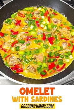 an omelet with sardines and vegetables cooking in a skillet