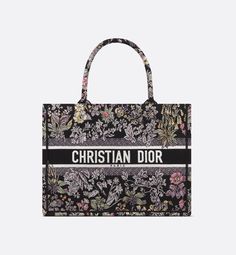 Introduced by Maria Grazia Chiuri, Creative Director of Christian Dior, the Dior Book Tote has become a staple of the Dior aesthetic. Created to hold all the daily essentials, the black style is fully embroidered with the multicolor Millefiori Unicorn motif by Pietro Ruffo, showcasing a symbol from Scottish mythology, the unicorn, within a poetic floral pattern. Adorned with the Christian Dior Paris signature on the front, the medium tote exemplifies the House's savoir-faire and can be carried b Dior Tote Bag, Dior Aesthetic, Dior Book, Flower Handbag, Book Tote Bag, Dior Book Tote, Embroidered Canvas, Maria Grazia Chiuri, Black Tote