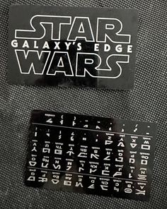 two star wars stickers are on the back of a suitcase, one is black and white