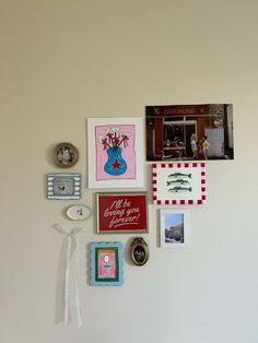 the wall is covered with pictures, magnets and other things that are hanging on it