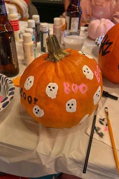 two painted pumpkins sitting on top of a table