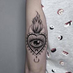 a woman's arm with an all seeing eye tattoo on it