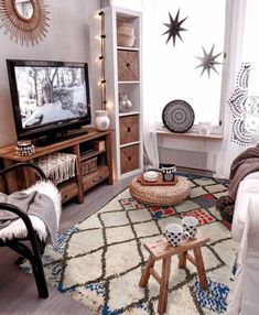 a living room filled with furniture and a flat screen tv on top of a wooden stand