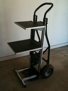 a hand truck with two shelves on the top and one shelf attached to the back