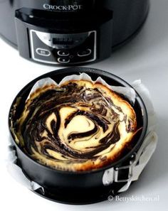 a pan filled with food sitting next to an instant pot and crock pot on top of a table