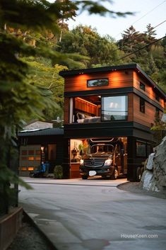 a car is parked in front of a house on the side of a mountain road