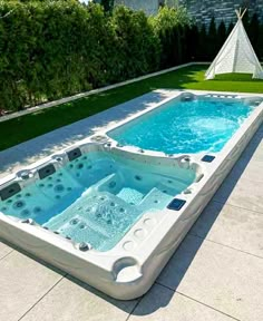 an outdoor hot tub in the shape of a teepeeh with blue water inside