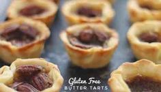 several small pies are lined up on a baking sheet with the words gluen free butter tarts