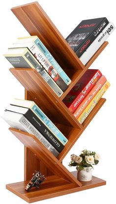 a wooden book shelf with several books on it and a flower vase in front of it