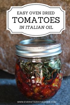 a mason jar filled with tomatoes and other vegetables next to a rock that says easy oven dried tomatoes in italian oil