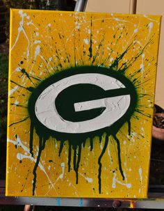 the green bay packers logo is painted on an easel