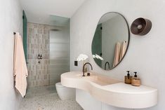 a bathroom with two sinks and a large mirror