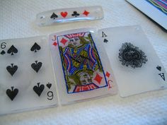 four playing cards are sitting on a table