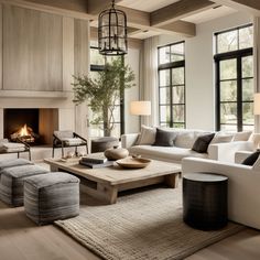 a living room filled with furniture and a fire place in the middle of a room