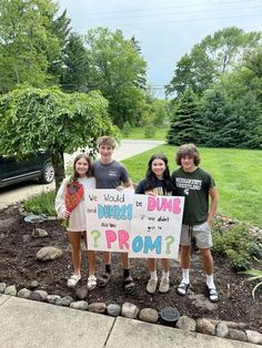 three children holding a sign that says do you know what they are doing prom?