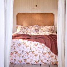 the bed is made up with floral sheets