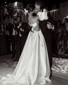 a bride and groom share their first dance