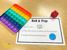 a roll and pop game with two dices on the paper next to each other