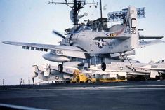 an aircraft carrier is parked on the tarmac with other planes in the foreground