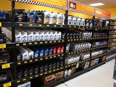 an aisle in a store filled with lots of different types of motor oils and other products