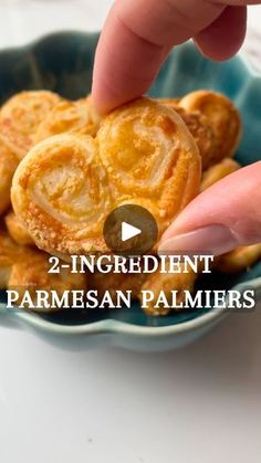 a person is picking up some food from a blue bowl with the words, 2 ingredient parmesan palmiers