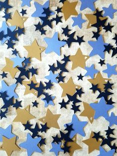 blue and gold stars are scattered on a white surface