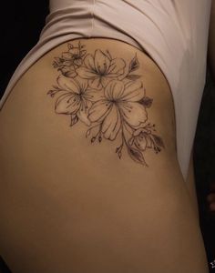 a woman's thigh with flowers on it