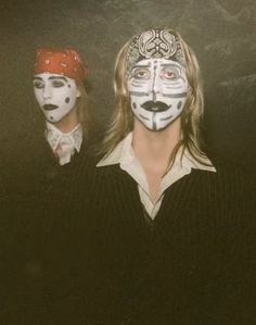 two people with painted faces standing next to each other