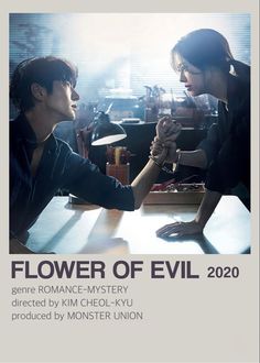 two people sitting at a table in front of a poster that says flower of evil