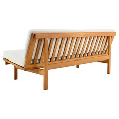 a wooden bench with white cushions on it