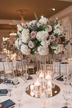 there are many vases with flowers in them on the table at this wedding reception