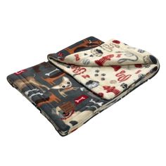 two blankets are folded on top of each other, one has an animal print and the other has a dog design