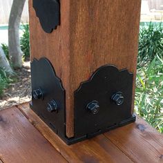 a close up of a wooden box on a table with metal handles and knobs