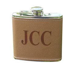 a brown leather flask with the initials jcc on it and a white background