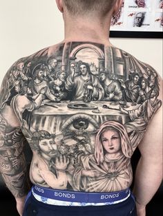 the back of a man with tattoos on his body