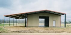 an empty building in the middle of a field with no grass or trees on it