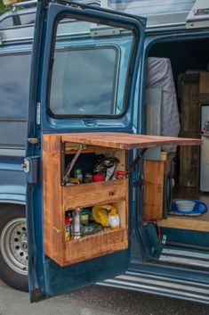 an open door on the back of a blue van