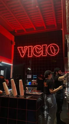 a group of people standing in front of a sign that reads vigo on it