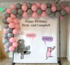 a birthday party backdrop with balloons and cartoon characters on the wall, along with a sign that says happy birthday reni and campbell