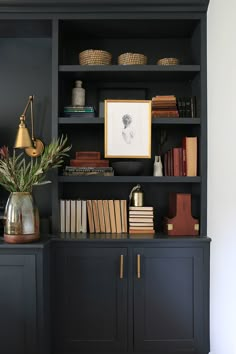 a bookshelf filled with lots of books and plants