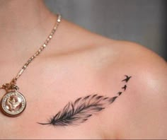 a woman's chest with a tattoo on it and a bird flying away from the feather