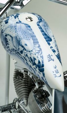 the motorcycle is decorated with blue and white designs