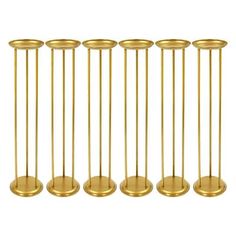 six brass candlesticks are lined up in a row