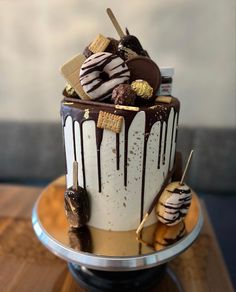 a cake with chocolate and marshmallows sitting on top of a wooden table