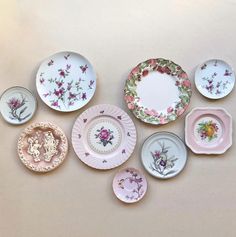 a collection of porcelain plates with flowers painted on them