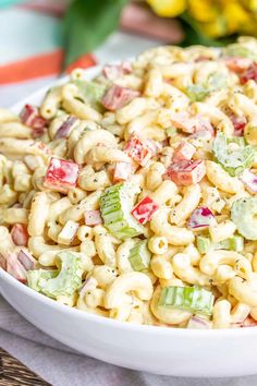 a white bowl filled with macaroni salad on top of a table