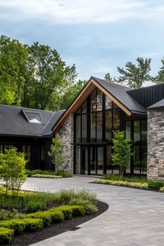 a large house with lots of windows and landscaping