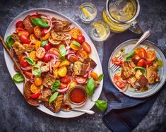 a white plate topped with meat and veggies next to a glass of beer